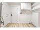 Laundry room with white cabinets and wood-look flooring at 6005 W Washington Ave, Las Vegas, NV 89107