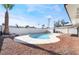 Relaxing kidney-shaped pool with surrounding patio and landscaping at 6005 W Washington Ave, Las Vegas, NV 89107