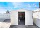 White storage shed with double doors and shelving at 6005 W Washington Ave, Las Vegas, NV 89107