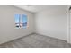 Bright bedroom with neutral wall and carpet, featuring a large window at 6270 Blood Lily Ave, Las Vegas, NV 89122