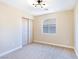 Well-lit bedroom featuring neutral carpeting and double door closet at 6529 Za Zu Pitts Ave # 102, Las Vegas, NV 89122