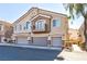 Townhouse exterior with two-car garage and balcony at 6529 Za Zu Pitts Ave # 102, Las Vegas, NV 89122