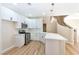 Modern white kitchen with an island and breakfast bar at 6529 Za Zu Pitts Ave # 102, Las Vegas, NV 89122