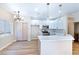 Modern kitchen with white cabinets and breakfast bar at 6529 Za Zu Pitts Ave # 102, Las Vegas, NV 89122