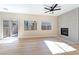 Living room with fireplace, wood-look floors, and sliding glass door to backyard at 6529 Za Zu Pitts Ave # 102, Las Vegas, NV 89122