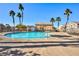 Community pool with surrounding lounge chairs and palm trees at 6529 Za Zu Pitts Ave # 102, Las Vegas, NV 89122