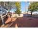 Backyard with mature trees and a gravel area at 6628 Silver Penny Ave, Las Vegas, NV 89108