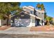 Two-story house with a gray facade and a two-car garage at 6628 Silver Penny Ave, Las Vegas, NV 89108