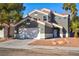 Two-story house with a gray facade and a two-car garage at 6628 Silver Penny Ave, Las Vegas, NV 89108