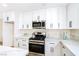 Modern kitchen with white cabinets, quartz countertops, and stainless steel appliances at 6628 Silver Penny Ave, Las Vegas, NV 89108