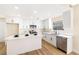 Modern kitchen with white cabinets, quartz countertops and island at 6628 Silver Penny Ave, Las Vegas, NV 89108