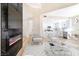 Open concept living room with a view of the kitchen and fireplace at 6628 Silver Penny Ave, Las Vegas, NV 89108