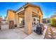 Covered patio with outdoor seating, grilling area, and lush greenery, creating an inviting outdoor living space at 6733 Violet Bluff Ct, North Las Vegas, NV 89084