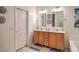 Double vanity bathroom with a large mirror and tiled floors at 6733 Violet Bluff Ct, North Las Vegas, NV 89084