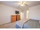 Bright bedroom with a dresser, large TV, and ensuite bathroom access at 6733 Violet Bluff Ct, North Las Vegas, NV 89084