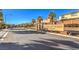 Upscale neighborhood entrance with stone signage, mature palm trees, and well-maintained landscaping at 6733 Violet Bluff Ct, North Las Vegas, NV 89084