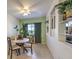 Bright dining room with built-in shelving and a charming table set for four at 6733 Violet Bluff Ct, North Las Vegas, NV 89084