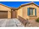 Attractive single-story home showcasing desert landscaping, garage, and an arched wrought iron front door at 6733 Violet Bluff Ct, North Las Vegas, NV 89084