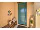 Welcoming entryway with a teal front door, bench, and decorative accents creating a warm ambiance at 6733 Violet Bluff Ct, North Las Vegas, NV 89084