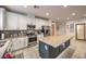 Modern kitchen with white cabinets, stainless steel appliances, large island, and stylish tile flooring at 6733 Violet Bluff Ct, North Las Vegas, NV 89084