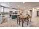 Spacious kitchen featuring an island, white cabinets, stainless steel appliances, and an adjacent dining area at 6733 Violet Bluff Ct, North Las Vegas, NV 89084