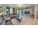 Living room with sectional sofa, large TV, and built-in shelving at 6733 Violet Bluff Ct, North Las Vegas, NV 89084