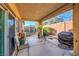 Covered patio with seating area, grill, and access to backyard at 6733 Violet Bluff Ct, North Las Vegas, NV 89084