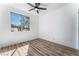 Spacious bedroom featuring wood-look floors and a ceiling fan at 6808 Rose Petal Ave, Las Vegas, NV 89130