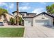 Two-story house with three-car garage and grassy front yard at 6808 Rose Petal Ave, Las Vegas, NV 89130