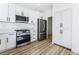 Modern kitchen with white cabinets and stainless steel appliances at 6808 Rose Petal Ave, Las Vegas, NV 89130