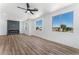 Living room with fireplace, hardwood floors, and ceiling fan at 6808 Rose Petal Ave, Las Vegas, NV 89130