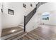 Modern staircase with black railing and light wood flooring at 6808 Rose Petal Ave, Las Vegas, NV 89130