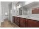 Bathroom with double vanity, large mirror, and tiled floor at 7131 Rosecrans St, Las Vegas, NV 89166