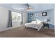 Bright bedroom with blue walls, ceiling fan, and comfortable bed at 7131 Rosecrans St, Las Vegas, NV 89166