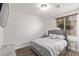 Main bedroom with a gray upholstered bed and wood floors at 7131 Rosecrans St, Las Vegas, NV 89166