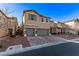 Two-story house with gray garage doors and landscaping at 7131 Rosecrans St, Las Vegas, NV 89166