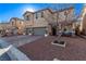 Two-story home with gray garage doors and landscaping at 7131 Rosecrans St, Las Vegas, NV 89166