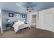 Main bedroom with blue accent wall, en-suite bathroom, and ceiling fan at 7131 Rosecrans St, Las Vegas, NV 89166