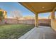 Covered patio overlooks a grassy backyard with mature trees and a storage unit at 7337 Savannah Falls St, Las Vegas, NV 89131