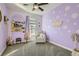 Charming bedroom with lavender walls, window seating, and giraffe decor at 7337 Savannah Falls St, Las Vegas, NV 89131