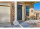 Inviting front porch with dark gray door and small sitting area at 7337 Savannah Falls St, Las Vegas, NV 89131