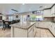 Kitchen with granite island, white cabinets, and breakfast bar seating at 7337 Savannah Falls St, Las Vegas, NV 89131