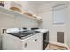 Bright laundry room with washer, dryer, and shelving at 7337 Savannah Falls St, Las Vegas, NV 89131