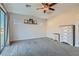 Main bedroom with gray carpet, ceiling fan, and access to balcony at 7337 Savannah Falls St, Las Vegas, NV 89131