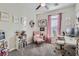 Home office with pink chair, desk, and ample shelving at 7337 Savannah Falls St, Las Vegas, NV 89131