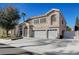 Two-story house with a three-car garage and landscaped front yard at 7420 Bush Garden Ave, Las Vegas, NV 89129