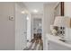 Bright hallway with wood-look floors and a white cabinet at 7420 Bush Garden Ave, Las Vegas, NV 89129