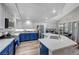 Modern kitchen with blue cabinets, island, and stainless steel appliances at 7420 Bush Garden Ave, Las Vegas, NV 89129