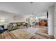 Bright living room with L-shaped sofa, coffee table, and wood-look floors at 7420 Bush Garden Ave, Las Vegas, NV 89129