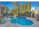 Long, inviting swimming pool surrounded by lush greenery at 7420 Bush Garden Ave, Las Vegas, NV 89129